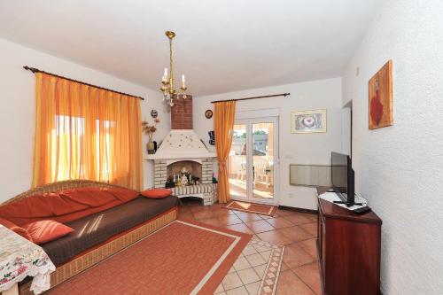 a living room with a couch and a fireplace at Apartment Božena in Nin