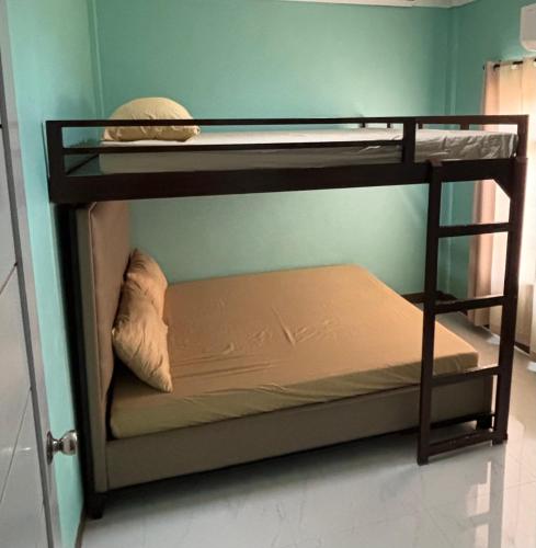 two bunk beds in a room with a pillow at Three Bedrooms Comfort Zone Guesthouse in Bengcag