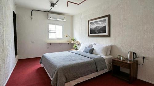 a hotel room with a bed and a window at Kinboshi Silom in Bangkok