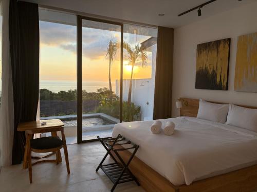 a bedroom with a bed with a view of the ocean at The Siren Resort Nusa Penida - Ocean View Villas in Nusa Penida