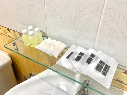 a bathroom with a glass counter and a sink at We Hostel in Hat Yai