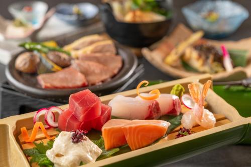 a tray of different types of food on a table at KAMENOI HOTEL Akita Yuze in Kazuno