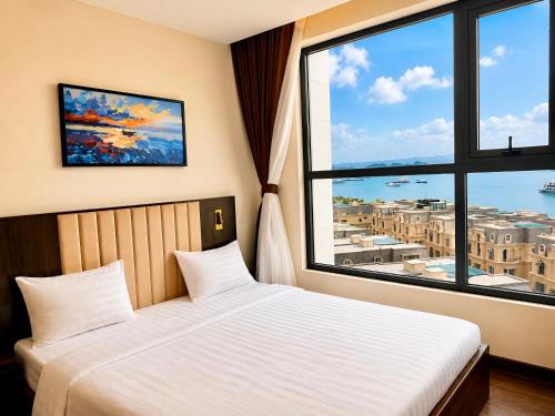 a bedroom with a bed and a large window at Luxury Ocean View Apartments - The Sapphire Ha Long, Studio & 2BR in Ha Long