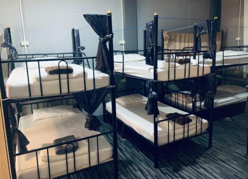 a group of four bunk beds in a room at We Hostel in Hat Yai