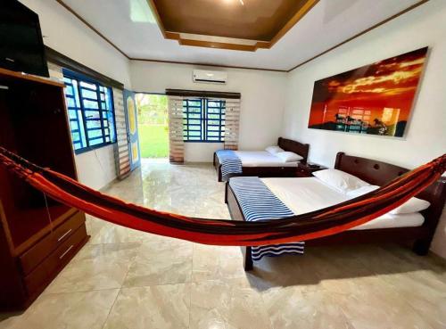 a hammock in a room with a bedroom at Finca Hotel La Potranca in Acacías