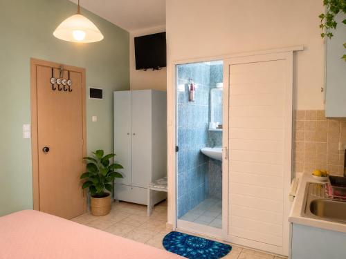 a bathroom with a shower and a sink and a sink at Klima Rooms in Palaiochora