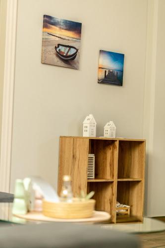 a table with a shelf and a picture on the wall at Elia Grove House in Néa Khilí