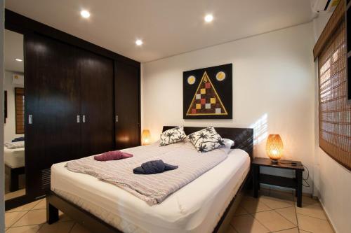 a bedroom with a large bed with two pillows on it at Garden Villa in Bali Residence Mae Phim with Kids Bunk Suite in Ban Bua Phut