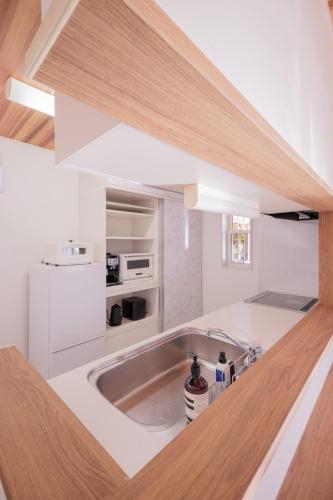 a kitchen with a sink and a counter top at Halema in Ichinomiya