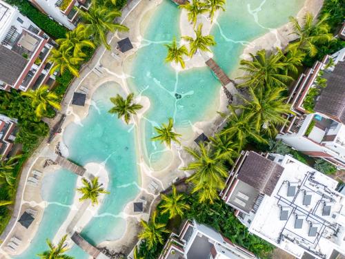 an overhead view of a pool with palm trees at Ama Villas - Luxury Private Villas in Mont-Choisy Beach in Mont Choisy