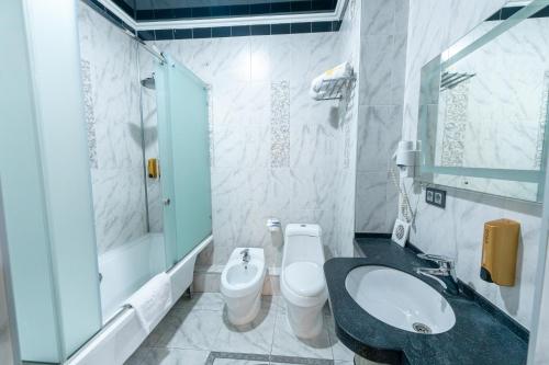 a bathroom with a sink and a toilet at Onyx Hotel Bishkek in Bishkek