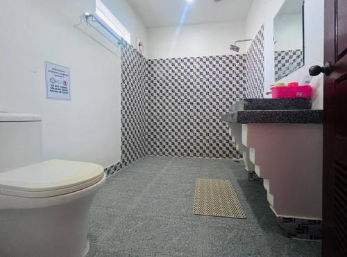 a bathroom with a white toilet and a shower at Monterey Angkor Boutique in Phum Pobos