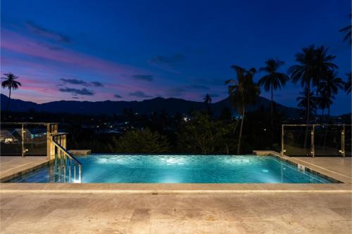 a swimming pool at night with a view at Panorama View Villa in Ban Thung
