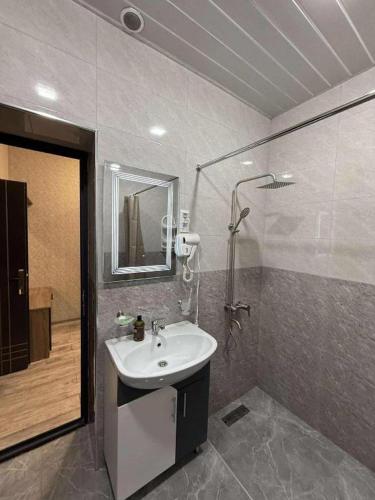 a bathroom with a sink and a shower at Bank Hotel in Yeghegnadzor