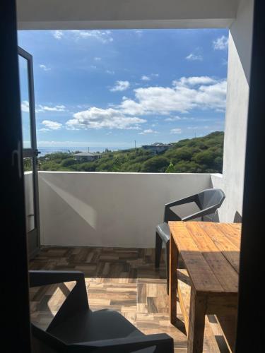 a view of a balcony with a table and chairs at Eagles Nest Residence - Apartment 2 in Rodrigues Island