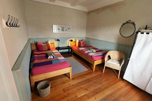 a room with two beds and a table in it at Ferienhaus Altes Schifferhaus in Oedelsheim