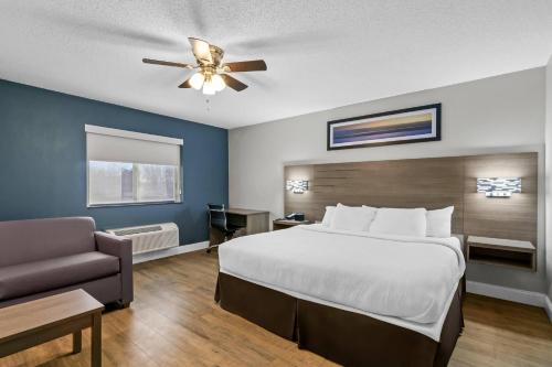 a hotel room with a bed and a couch at Quality Inn Neosho in Neosho