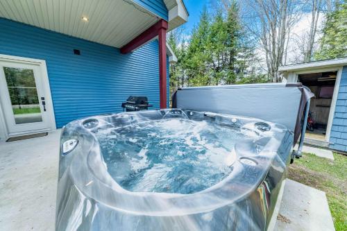 a hot tub in front of a house at Spa Relaxation & Adventure - Lapointe du Lac in Saint-Gérard