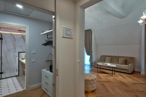 a living room with a couch and a table at Hotel Premiere Abano in Abano Terme
