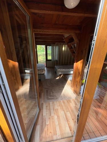 an open glass door of a room with a couch at Przystań Kownatki in Kozłowo