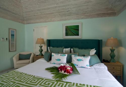 a bedroom with a large bed with flowers on it at Bequia Plantation Hotel in Bequia