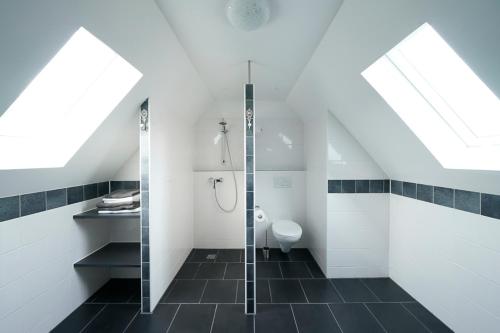 a bathroom with a glass shower and a toilet at Ferienhaus Lemmerheide in Rüthen