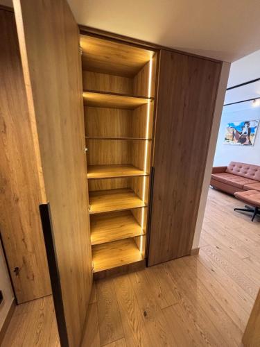 a closet with a wooden door in a room at Marių vilos apartamentai Balcony with a Lagoon View in Juodkrantė