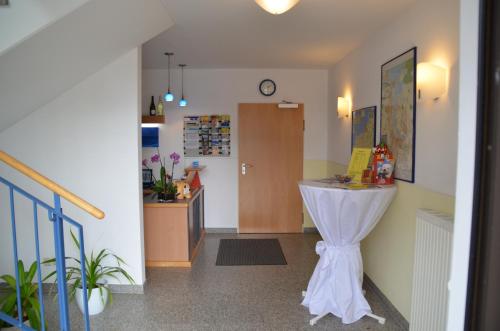 a hallway with a room with a table in it at Hotel-Pension Pastow Garni in Broderstorf