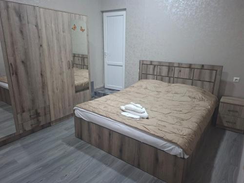a bedroom with a bed with two towels on it at Star Zvartnots Hotel in Pʼarakʼar