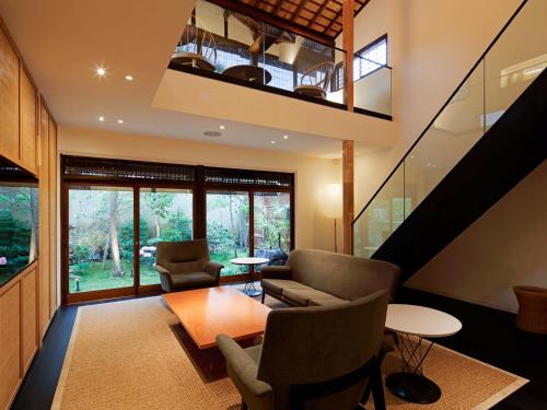 a living room with a loft with a table and chairs at 翠門亭 in Nara