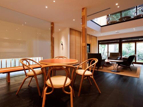 a dining room with a table and chairs at 翠門亭 in Nara