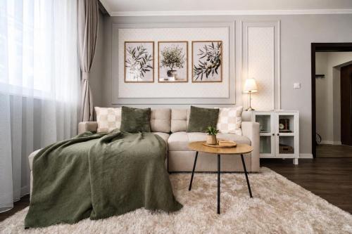 a living room with a couch and a table at Cozy & Elegant Stay in Veliko Tŭrnovo