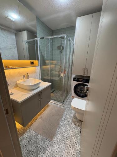 a bathroom with a sink and a shower and a toilet at Panoramic Sea View in Budva