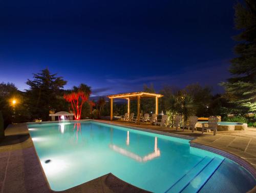 a swimming pool at night with a gazebo at Blumenau Relax & Holidays in Villa General Belgrano