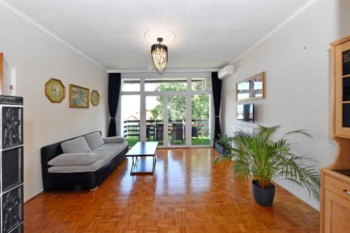 a living room with a couch and a table at Blackbird Apartment in Balatonfüred