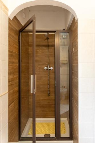 a shower with a glass door in a bathroom at La Casa di Dadà in Avezzano
