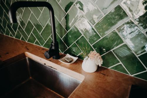 a kitchen sink with two utensils on a counter at View Street Studios - Tallerack in Albany