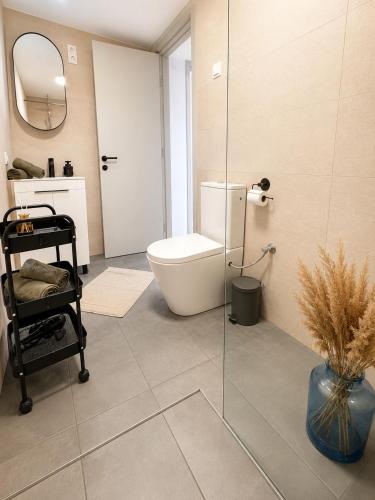 a bathroom with a toilet and a glass shower at Peaceful Garden Hideaway in Gárdony