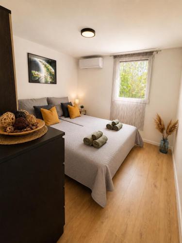 a bedroom with a large bed and a window at Peaceful Garden Hideaway in Gárdony