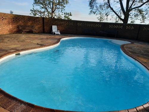 a large pool with blue water in a yard at Fountainhill Estate Accommodation in Wartburg