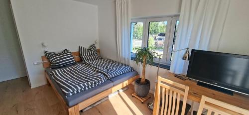 a living room with a couch and a flat screen tv at Apartments Leipziger Neuseenland in Markkleeberg