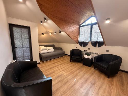 a living room with two chairs and a couch and a bed at Mountain Symphony Cottage Dilijan in Dilijan