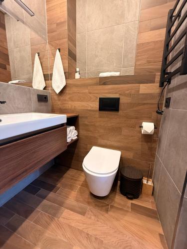 a bathroom with a toilet and a sink at Mountain Symphony Cottage Dilijan in Dilijan