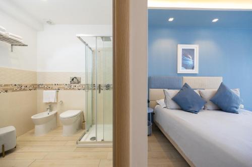a bedroom with a bed and a bathroom with a shower at Relais Villa Anna in Anacapri