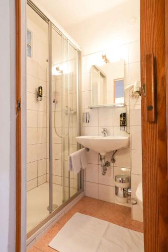 a bathroom with a shower and a sink at Strandhotel Pichler in Seeboden