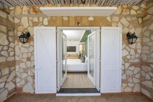 a room with doors leading to a bedroom at Relais Villa Anna in Anacapri
