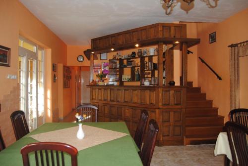 a dining room with a table and a staircase at Villa Hedi in Dunakiliti