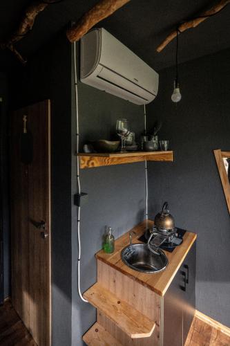 a kitchen with a sink and a stove at Kajuta in Betliar