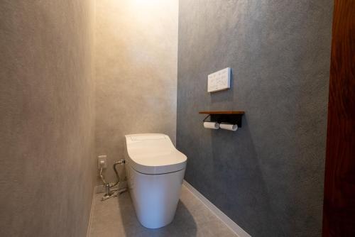 a bathroom with a white toilet in a room at yutori-nozawa in Nozawa Onsen