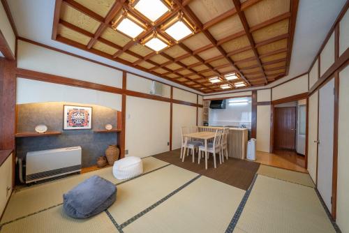 a living room with a table and a television at yutori-nozawa in Nozawa Onsen